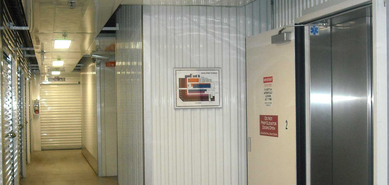 hallway storage unit doors and-elevator with floor plan sign